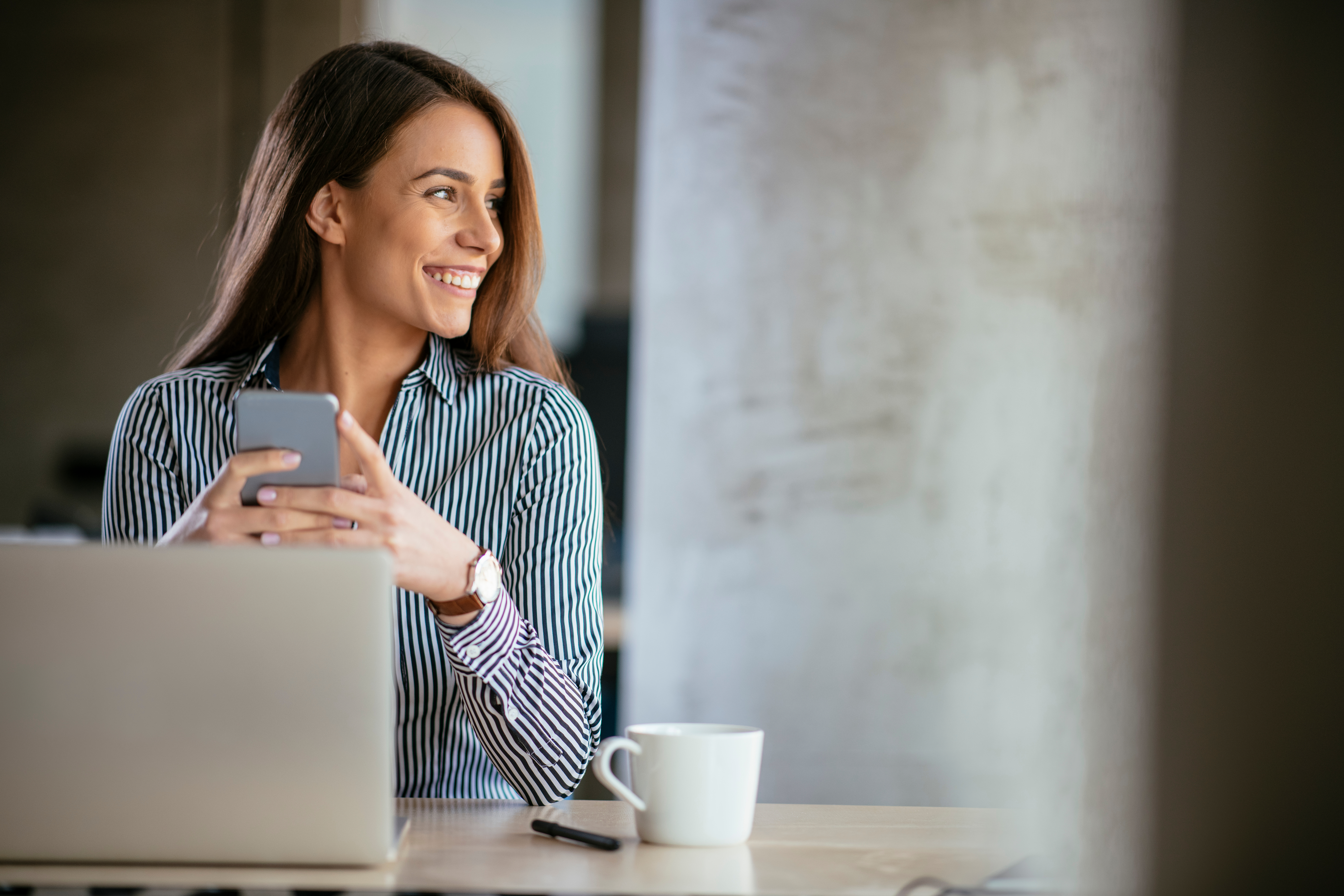 Young,Business,Woman,On,The,Phone,At,Office.,Business,Woman